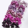 Set of purple and pink scrunchies on a white background