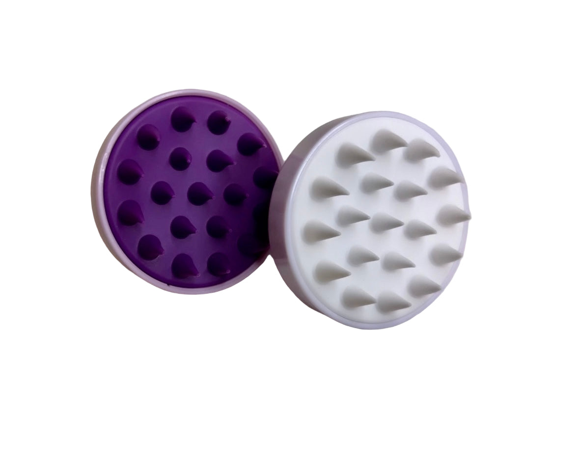 Two round objects, one purple and one white, with textured surfaces on a light beige background.