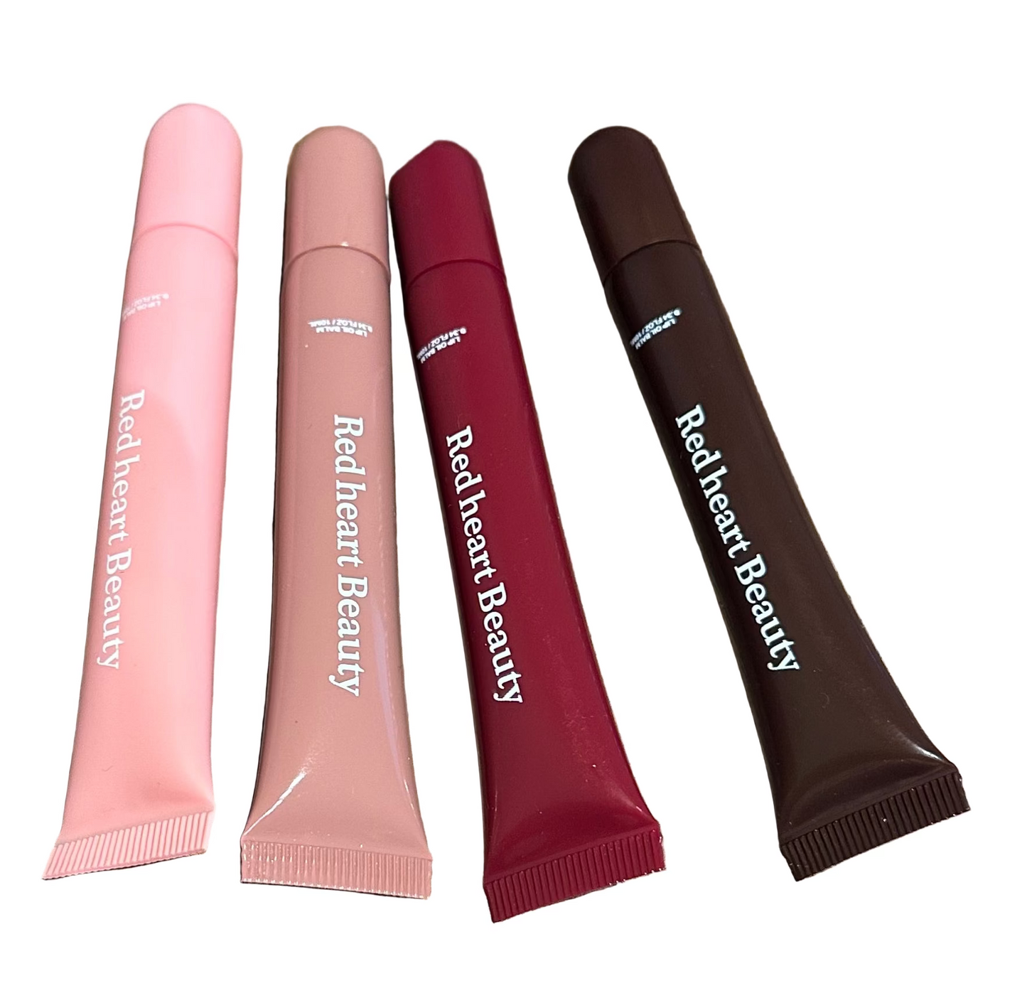 Four tubes of Red heart Beauty product on a wooden surface