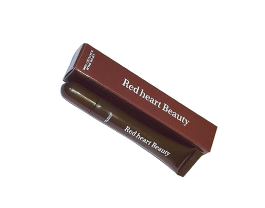 Red Heart Beauty lip gloss on a white paper with a wooden surface underneath