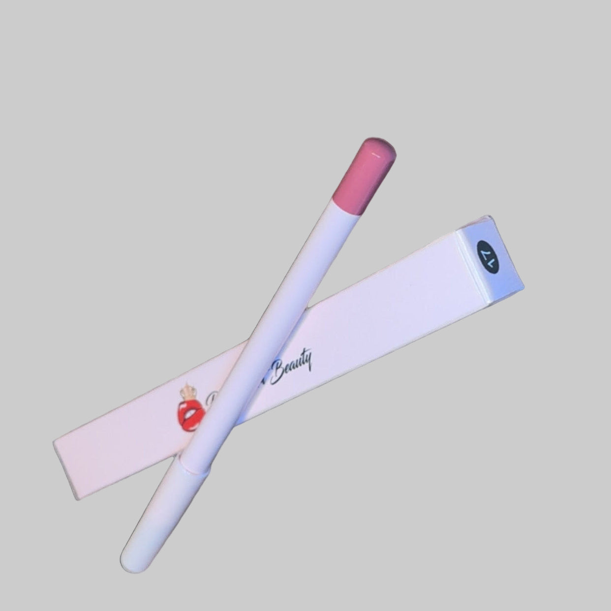 Two lip products on a textured surface