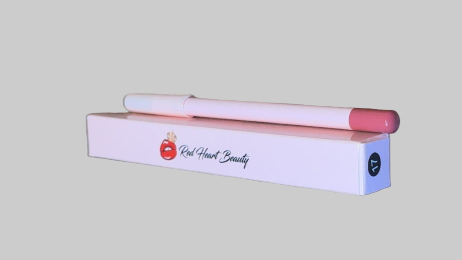 Pink lip gloss with applicator on a wooden surface
