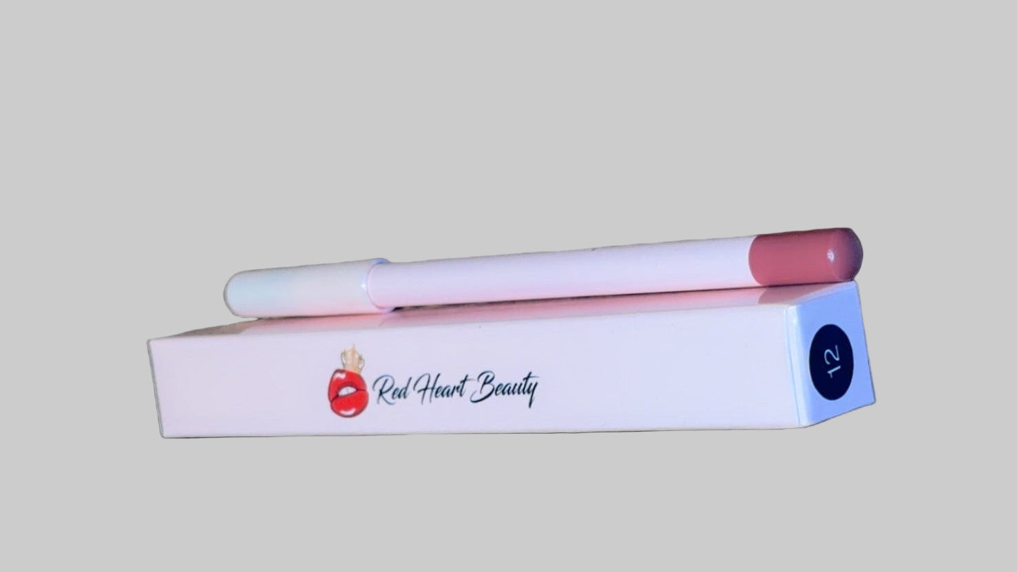 Lipstick and its packaging on a textured surface