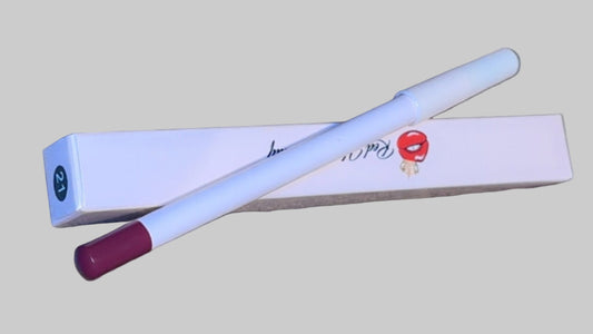 White pen with red cap on a textured surface